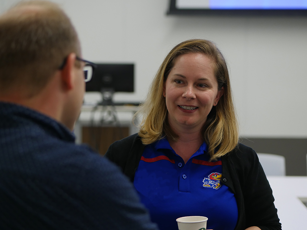 A Ph.D. student talks with a faculty member during orientation.