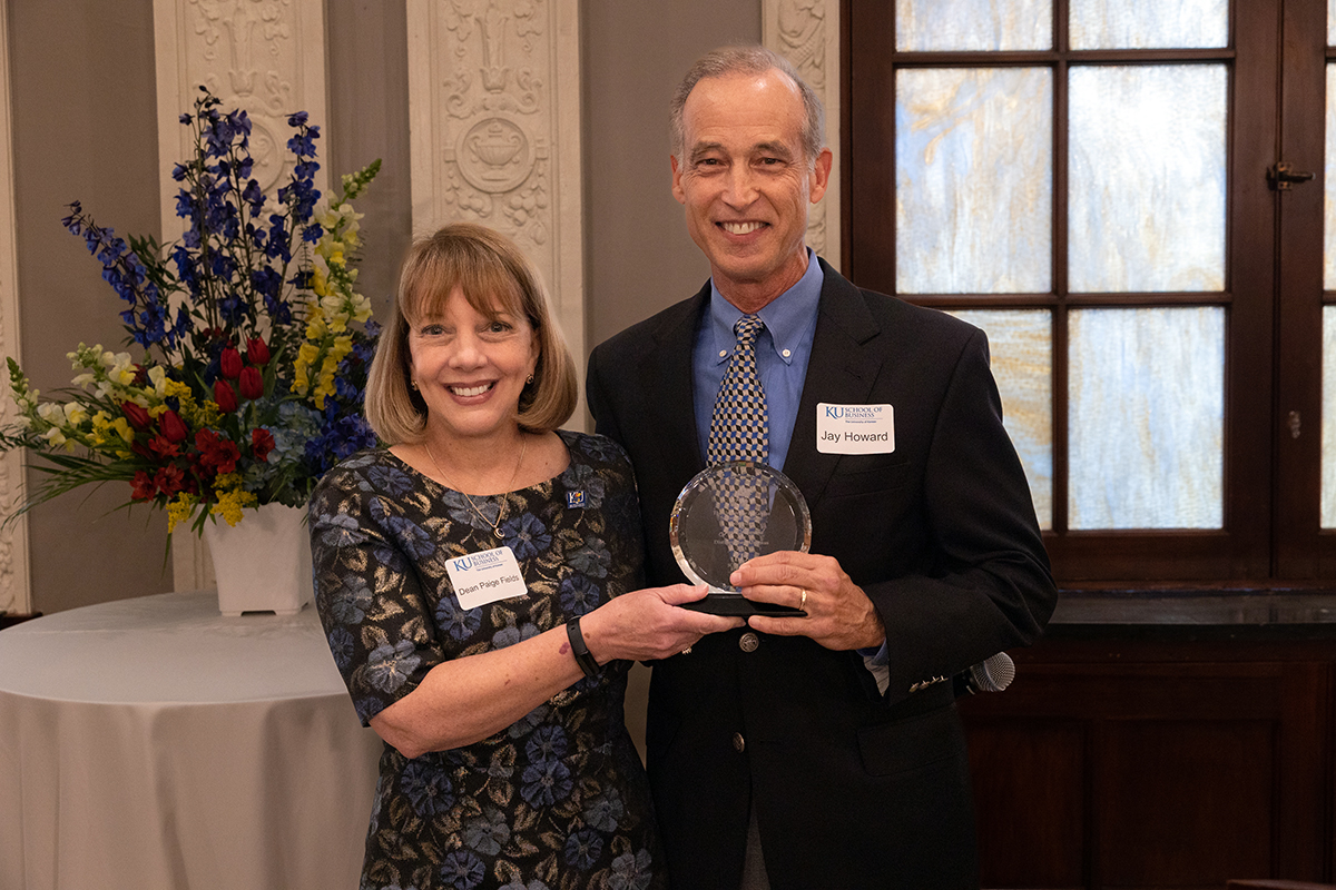 Dean Fields holds the Distinguished Alumni Award with 2023 recipient Jay Howard
