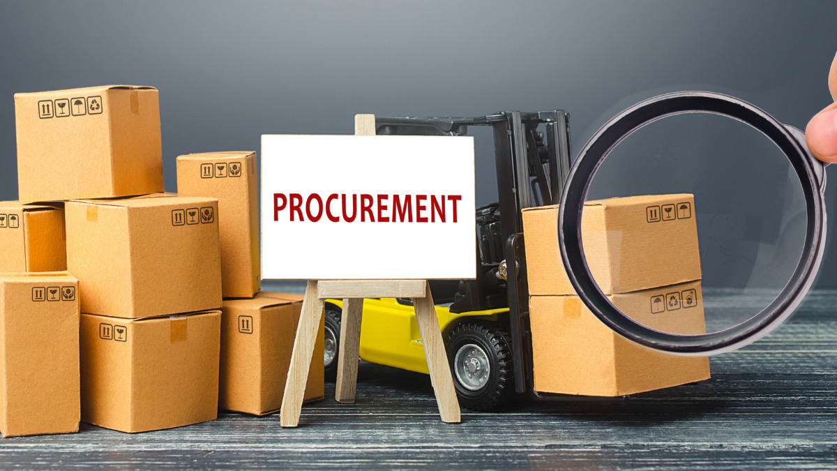 Rendering of a board with the word "procurement" on an easel next to stacked boxes