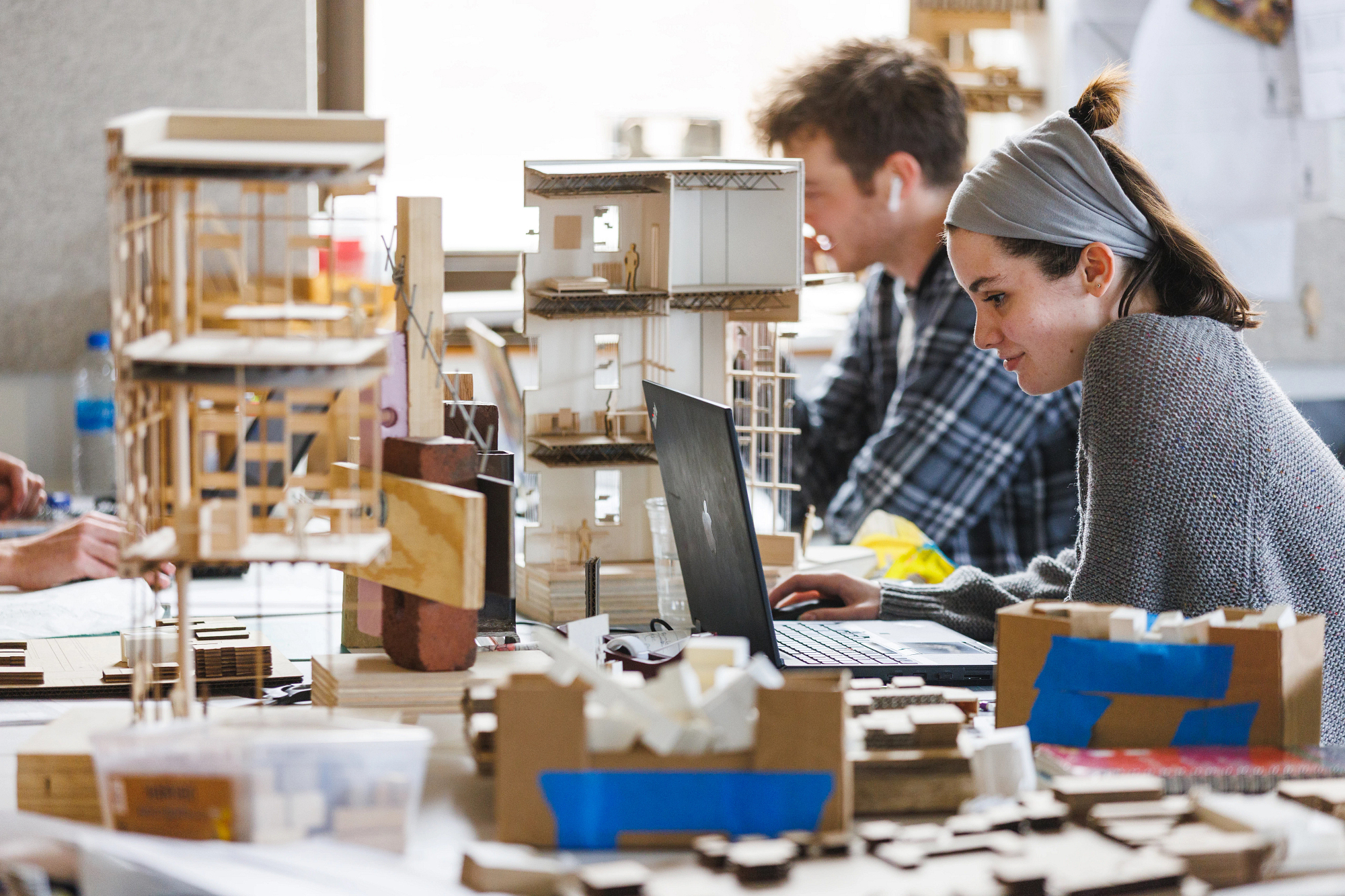 Two students work on a model in an architecture studio