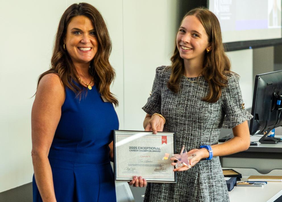 Award nominator Kaitlyn Chapman accepts an award from KU Business Relations Coordinator Cheryl Webb, on behalf of Tim Leonard with CA Carlin