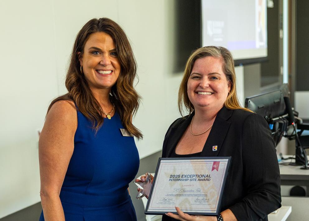 Lindsey Slater of KU Innovation Park accepts an award from Cheryl Webb, KU business relations coordinator