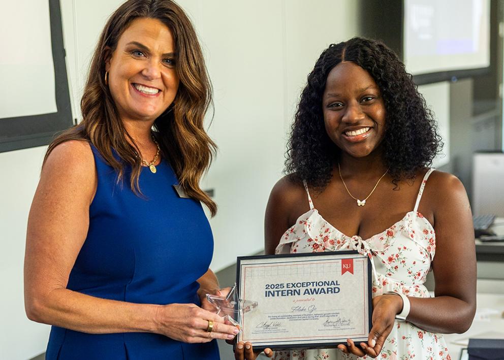 Folake Ojo accepts her award from Cheryl Webb, KU business relations coordinator