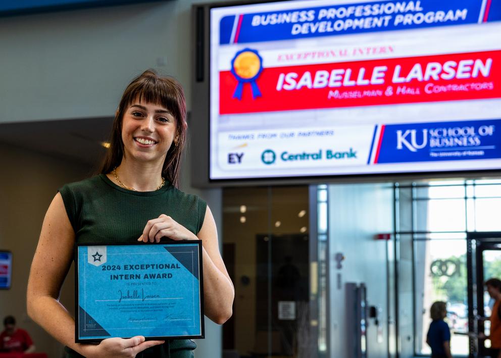 Isabelle Larsen holds the 2024 Exceptional Intern Award from the EY Business Professional Development Program