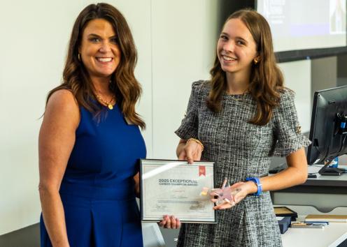 Award nominator Kaitlyn Chapman accepts an award from KU Business Relations Coordinator Cheryl Webb, on behalf of Tim Leonard with CA Carlin