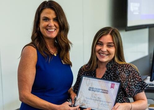 Peyton Minter with Choice Solutions accepts an award from Cheryl Web, KU business relations coordinator