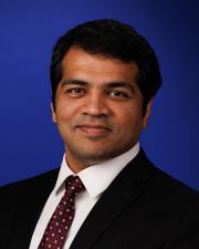 Photo of Karthik Srinivasan against a blue background