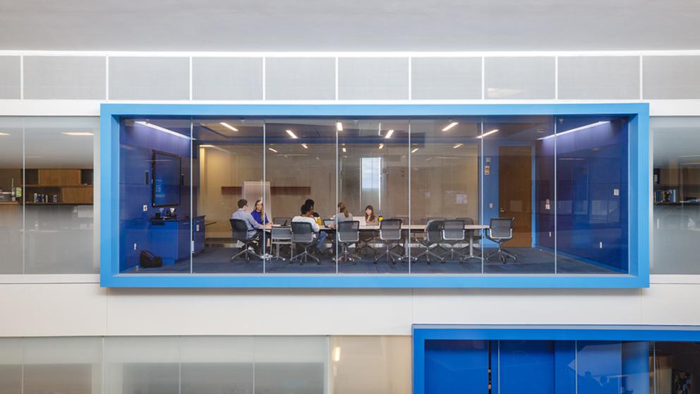 Students sit around a table in a conference room on the fourth floor of Capitol Federal Hall.
