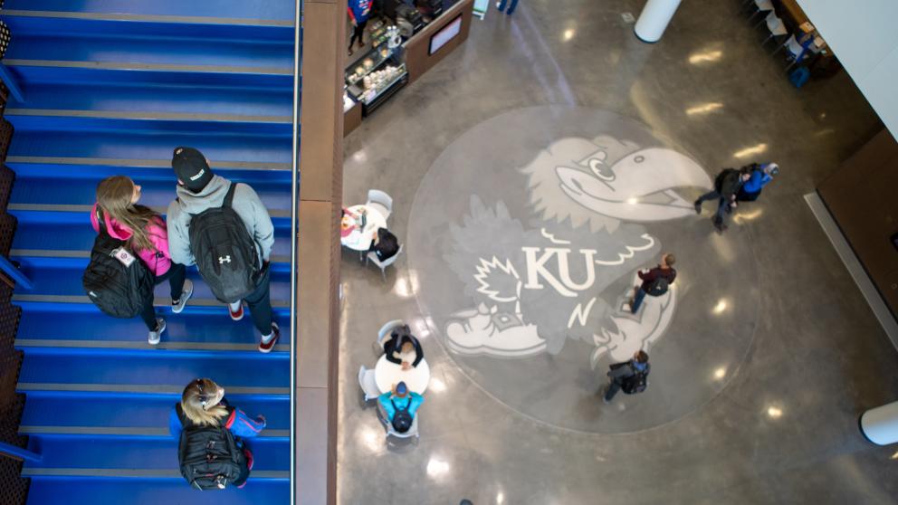 Overhead view of stairs and Jayhawk on floor of atrium in Capitol Federal Hall